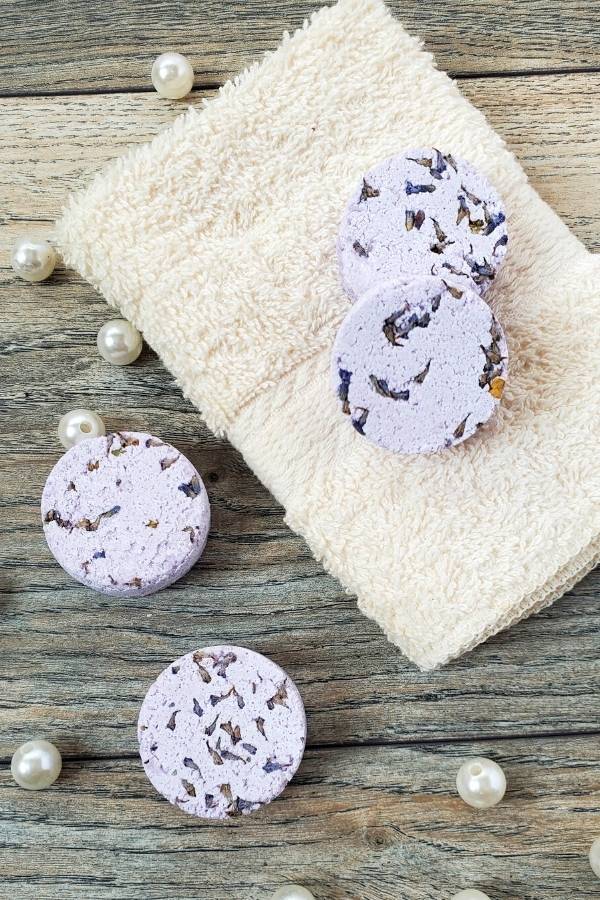 Learn how to make a lavender shower steamers recipe without citric acid. These easy aromatherapy shower steamers can be made with lavender essential oil or a lavender essential oil blend to help relieve stress and calm your mind.
